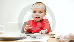 Happy child baby girl toddler sitting with keyboard of computer isolated on a white background