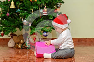 Happy child baby toddler kid with a Christmas gift.