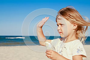 happy child on the beach near the swimming pool outdoors eating ice cream in summer park