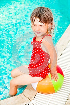 happy child on the beach near the swimming pool outdoors in summer park