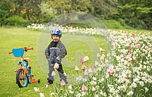 Happy child with bike in park