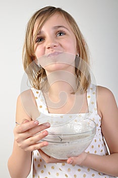 Happy child with a bowl of milk porridge