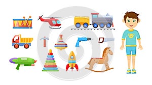 Happy child boy with childish toy set. Children playthings drum, railway, train, helicopter, truck