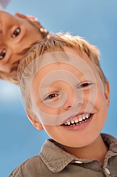 Happy, child and boy face in summer with a smile feeling happiness outdoor ready to play. Portrait of children, kids and
