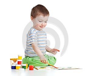 Happy child boy with paints