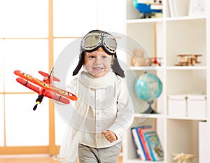 Happy child boy play in airplane indoors