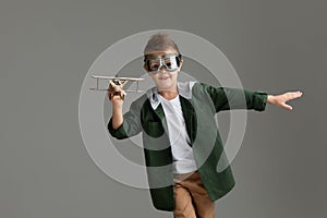 Happy child boy playing with wooden toy airplane. dream