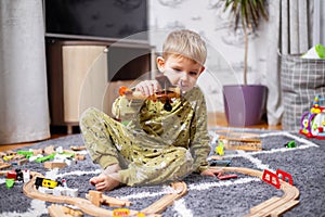 Happy child boy plays with toy airplane and dreams of becoming a pilot