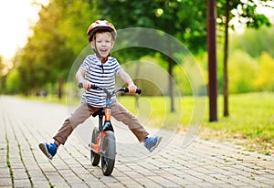 Happy child boy rides a racetrack in Park in summer