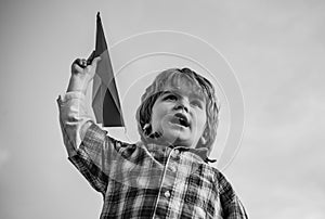 Happy child boy running on meadow with toy airplane in summer in nature. Little cute boy playing with a toy airplane