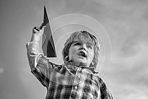 Happy child boy running on meadow with toy airplane in summer in nature. Little cute boy playing with a toy airplane