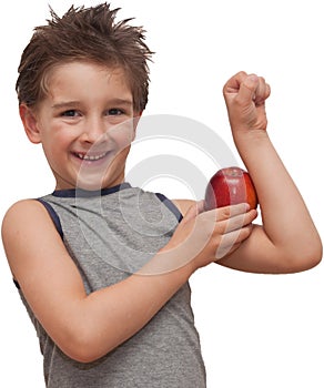 Happy child boy showing muscle apple