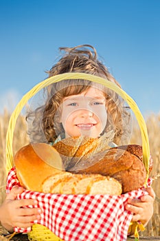 Happy child with bread in basket