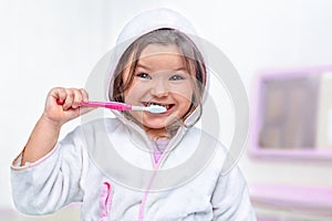Happy child brushing teeth