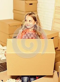 Happy child cardboard box. playing into new home. new apartment. happy little girl. Cardboard boxes - moving to new