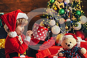 Happy child with Christmas gift. New year kids. Cheerful cute child opening a Christmas present. Christmas child holding