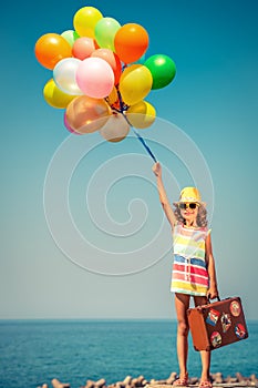 Happy child with colorful balloons