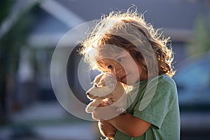 Happy child and dog hugs her with tenderness smiling.