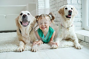 Happy child with a dog. Portrait of a girl with a pet. Labrador Retriever at home.