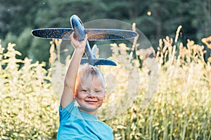 Happy child dreams of traveling and playing with an airplane