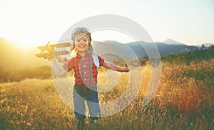 happy child dreams of traveling and playing with an airplane pilot aviator in outdoor