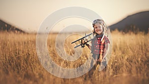 happy child dreams of traveling and playing with an airplane pilot aviator in outdoor