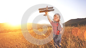 happy child dreams of traveling and playing with an airplane pilot aviator in outdoor