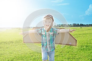 Happy child dreams of traveling and playing with an airplane pilot aviator in outdoor in the summer. Start traveling