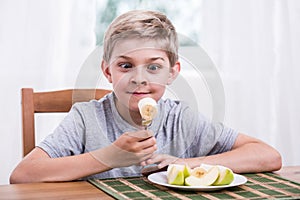 Happy child eating banana