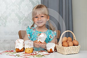 Happy child eating easter cake and eggs