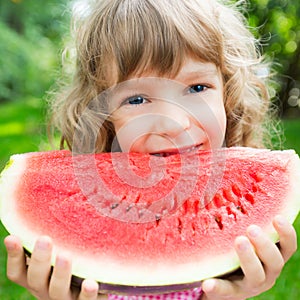 Happy child eating watermelon