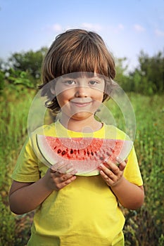 Happy child eating watermelon