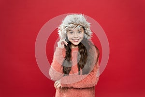 Happy child enjoy warmth. happy little girl in earflap hat. holiday activity outdoor. small child ready for winter