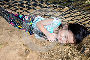 Happy child enjoying and relaxing in hammock, sweet dream and sm