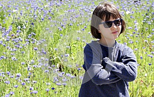 Happy child enjoying relaxing sun, observing nature at springtime