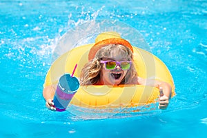 Happy child enjoying summer vacation outdoors in the water in the swimming pool.