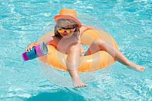 Happy child enjoying summer vacation outdoors in the water in the swimming pool.