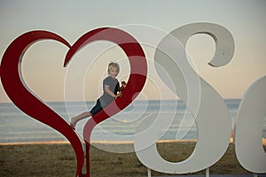 Happy child with family, ejoying the beach alley in Sarti, Greece on sunset