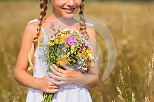Happy child with filed bouquet