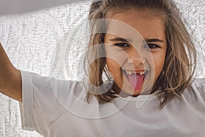 Happy child. Funny girl playing with a blanket. Smiling child girl. Cheerful child outdoors in nature