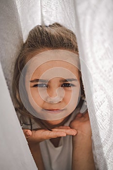 Happy child. Funny girl playing with a blanket. Smiling child girl. Cheerful child outdoors in nature