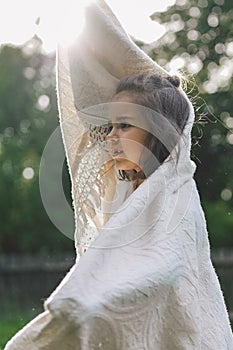 Happy child. Funny girl playing with a blanket. Smiling child girl. Cheerful child outdoors in nature