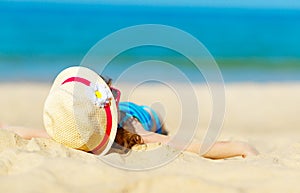 Happy child girl in bikini on beach in summer sea