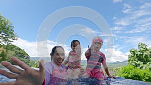 Happy child girl diving underwater in swimming pool. Family summer vacation.