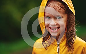 Happy child girl enjoying autumn rain