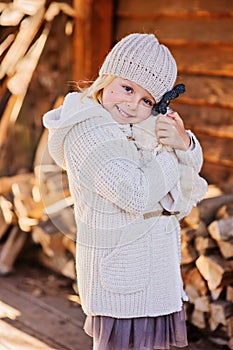 Happy child girl hugs her teddy bear