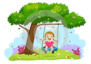 Happy child girl laughing and swinging on a swing under the tree