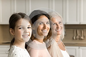 Happy child girl, mom and cheerful grandma posing for shooting