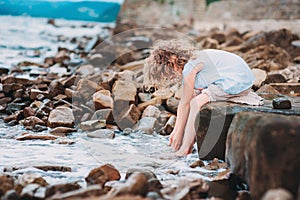 Happy child girl playing on the beach