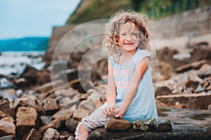 Happy child girl playing on the beach